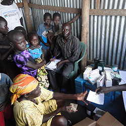 Families and children lining up for treatment at a refugee camp in South Sudan - Elizabeth Ekang