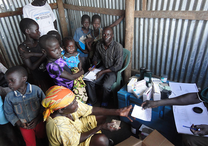 Families and children lining up for treatment at a refugee camp in South Sudan - Elizabeth Ekang